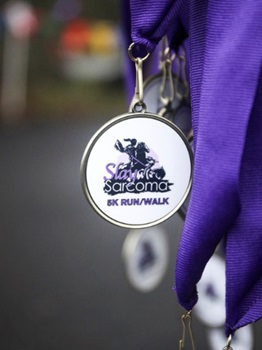 Medal that says Slay Sarcoma 5K Run/Walk
